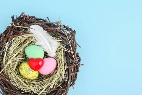 Red heart and easter egg nest flatlay. Stock Photos