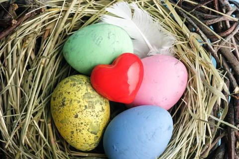 Red heart and easter egg nest flatlay. Stock Photos