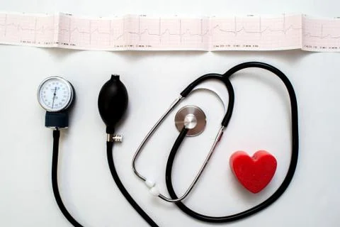 Red heart and a stethoscope on desk Stock Photos