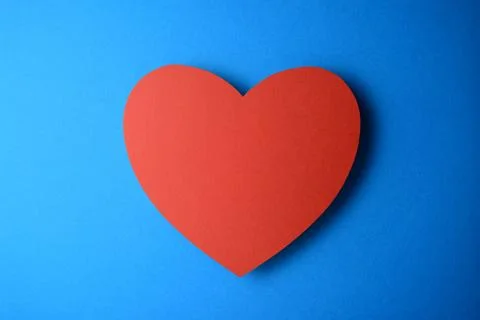 Red heart on blue background Stock Photos
