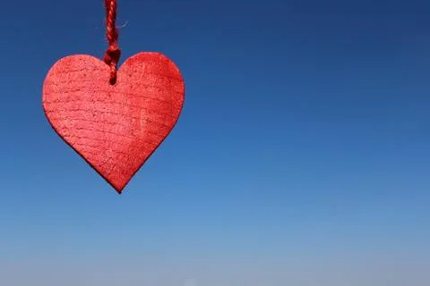 Red heart on the blue sky Stock Photos