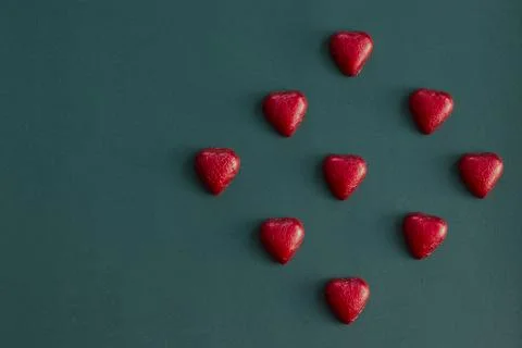 Red heart chocolates pattern on dark background Stock Photos