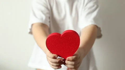 Red heart close up in hands of kid boy  on Valentines Day. Stock Footage 147452361