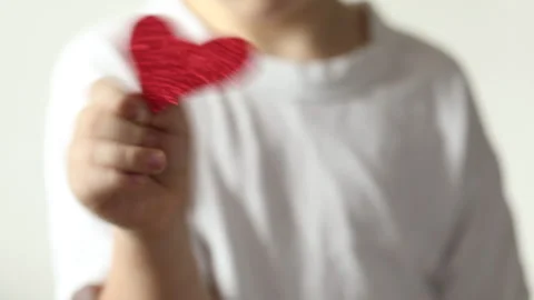 Red heart close up in hands of kid boy  on Valentines Day. Stock Footage 147452507
