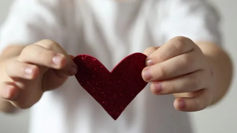 Red heart close up in hands of kid boy  on Valentines Day. Stock Footage 147452543