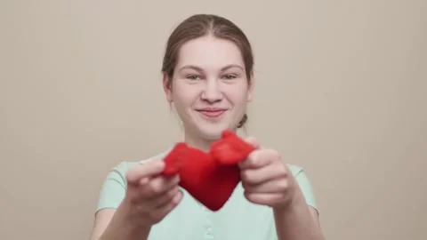 Red heart close up in hands of smiling caucasian teenager on Valentines Day. Stock Footage 145990205