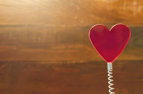 Red Heart On Coil Spring. Rustic Wooden Background. Saint Valentines Day Stock Photos