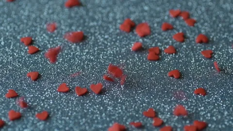 Red heart confetti fall blue glitter surface Stock Footage 146752465