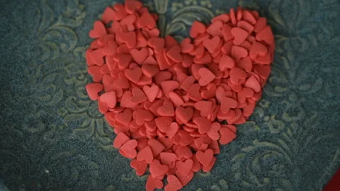 Red heart confetti fall green plate slow motion Video stock 146749587