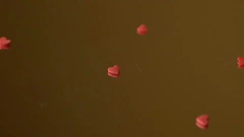Red heart confetti fall scatter on mirror surface Stock Footage 146752010