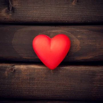 Red heart on the dark boards Stock Photos