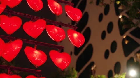 Red Heart Decorations infront Modern Architecture city Building at Night Video stock 338369410