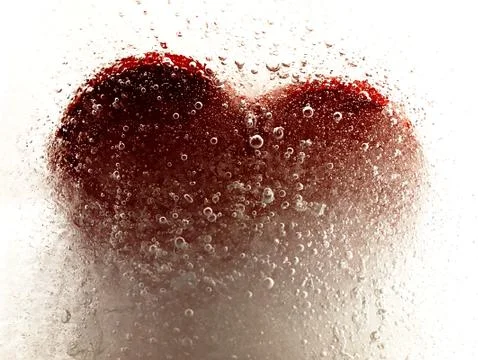 Red heart embedded in ice. Stockfoto's