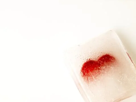 Red heart embedded in ice. Stock Photos