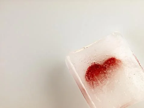Red heart embedded in ice. Stock Photos
