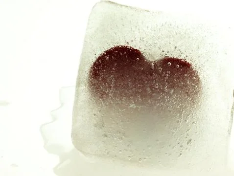 Red heart embedded in ice. Stock Photos