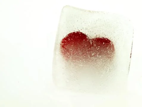 Red heart embedded in ice. Stock Photos
