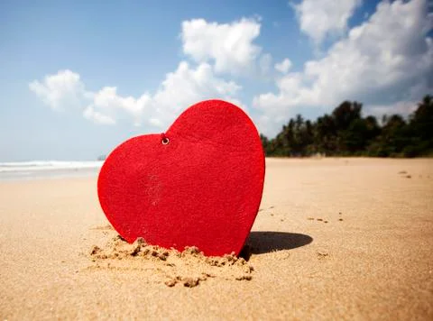 Red heart on exotic sandy beach - Valentine's day concept Stock Photos