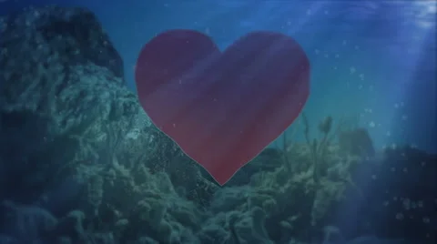 Red Heart floating underwater Stock Footage 58596433
