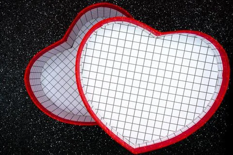 Red heart gift box on dark glitter background Stock Photos