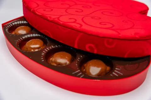 A Red Heart Gift Box With Gourmet Chocolates Inside on a White Background Stock-Fotos