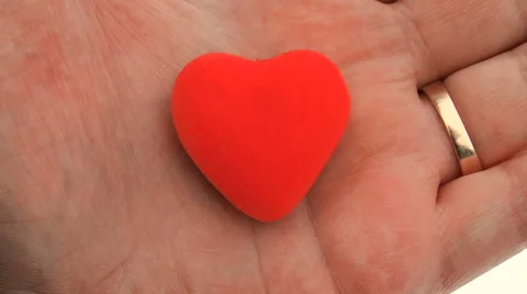 Red heart in hand. Clous up. Background Stock Footage 68266162