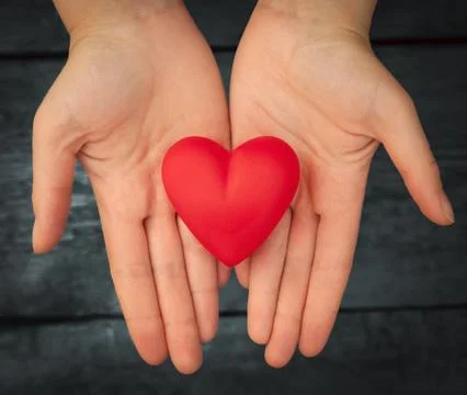 Red heart in the hands Foto stock