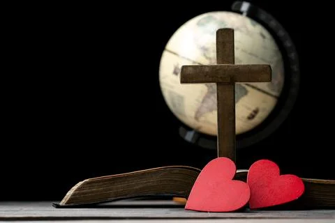 The red heart on holy bible book is the symbol of love from God. The God gi.. Stock Photos
