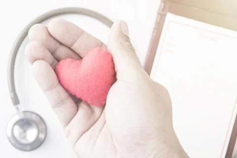 Red heart in human hand with dramatic tone Stock Photos