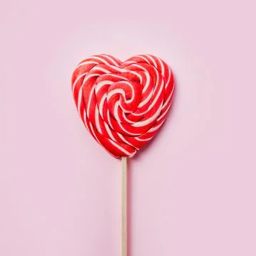 Red heart lollipop on pink background love and Valentine day background Stock Photos