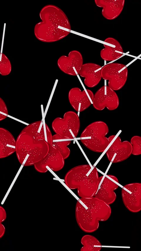 Red Heart Lollipops Falling Against a Solid Black Background Stock Footage 345037992
