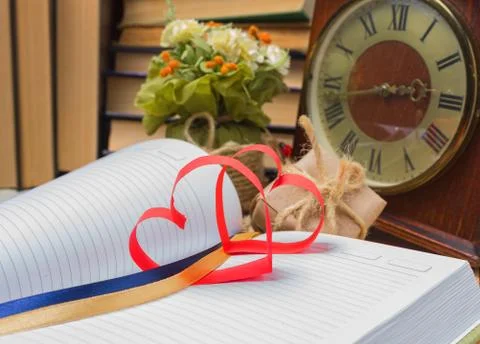 Red heart made of paper notebook and clock. Love Stock Photos