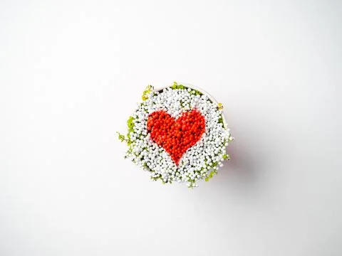Red heart made of tiny balls in a cup, top view, symbol, valentines day conce Stock Photos