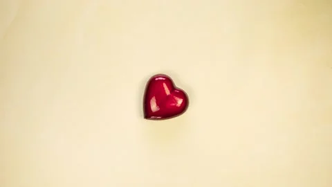 Red heart moving from right to left on yellow background. Saint valentine day Stock Footage 233211029