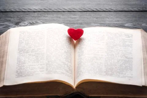 Red heart on an open book Stock Photos
