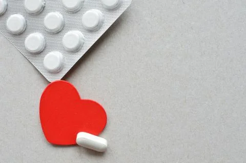Red heart with packing of tablets Stock Photos