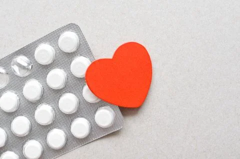 Red heart with packing of tablets Stock Photos