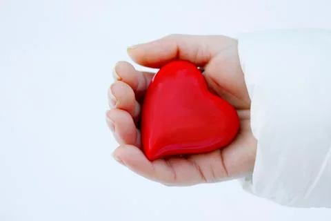 Red heart in palm Stock Photos