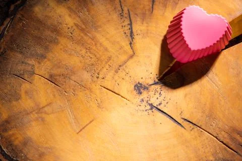Red heart with a pattern on a cracked sawn tree with bark Stock Photos