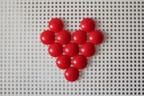 Red heart on pegboard mushroom nail mosaic Stock Photos