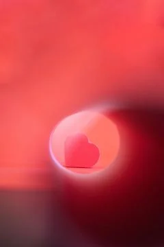 Red heart on red background with light effects Stock Photos