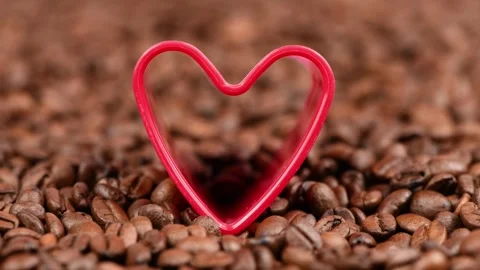 Red heart in roasted coffee beans background. Stock Footage 249951958