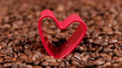 Red heart in roasted coffee beans background. Stock Footage 249952018