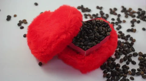 Red heart shape box, its lid and spilling coffee beans. Stock Footage 37205527