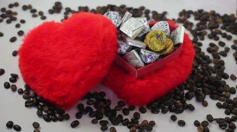 Red heart shape candy box and spilled coffee beans. Stock Footage 37178275