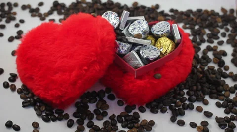 Red heart shape candy box and spilled coffee beans. Stock Footage 37204752