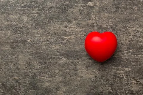 Red heart shape on colored background. minimal concept top view with copy spa Stock Photos