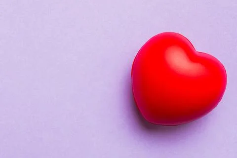 Red heart shape on colored background. minimal concept top view with copy spa Stock Photos