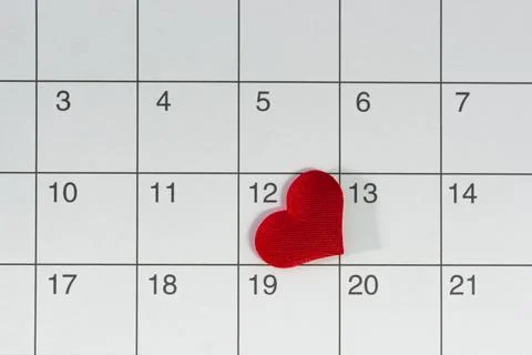 Red heart shape on the date of the 12th day in the calendar. Stock Photos