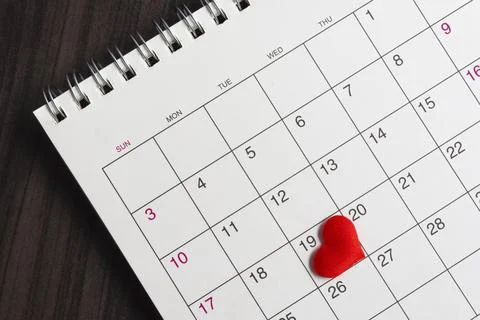 Red heart shape on the date of the 19th day in the calendar. Stock Photos